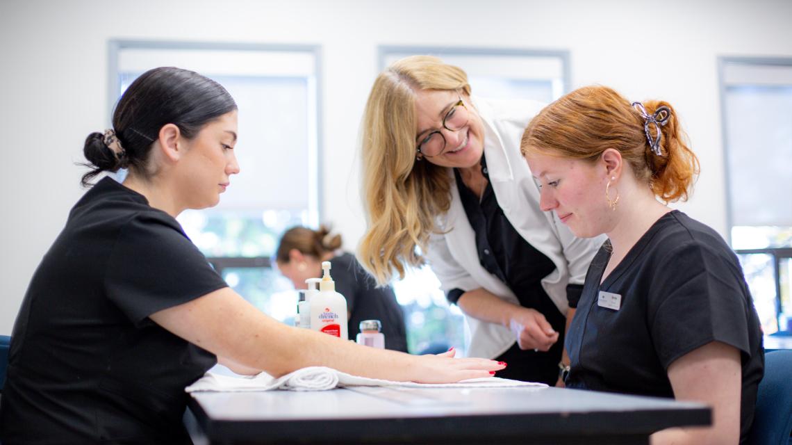 esthetics students and instructor manicure