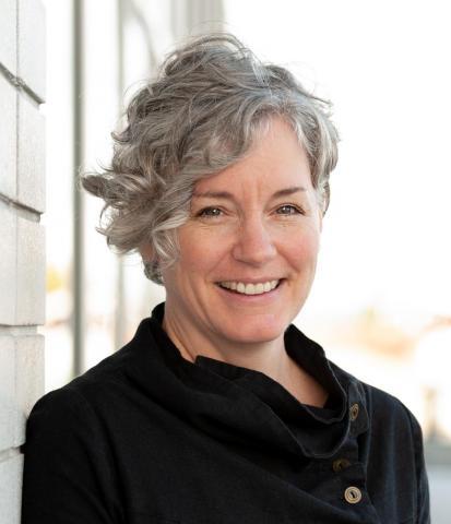 Smiling woman with grey hair. 